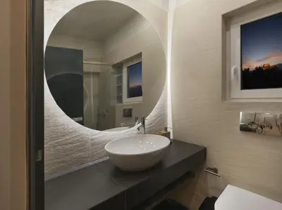 a bathroom with a white sink and a mirror at Iliodorou2-4 in Athens