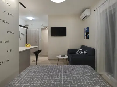 a bedroom with a bed and a couch and a desk at Iliodorou2-4 in Athens