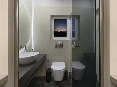 a bathroom with a white toilet and a sink at Iliodorou2-4 in Athens