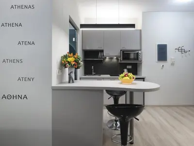 a kitchen with white cabinets and a white counter top at Iliodorou2-4 in Athens