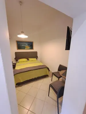 a bedroom with a bed and a table and chairs at ANAFIS COZI in Athens