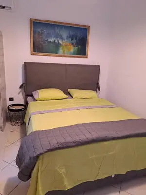 a bed in a room with a picture on the wall at ANAFIS COZI in Athens
