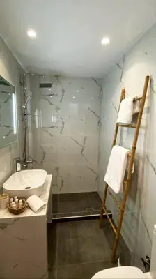 a bathroom with a shower and a sink and a toilet at Sea Through Apartment Anavissos in Anavissos