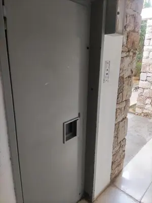 a door in a room with a stone wall at VOULIAGMENI RIVIERA center between Beach and Lake in Athens