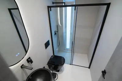 a bathroom with a shower and a toilet and a mirror at White House Vouliagmeni 1- 2BD Free Parking, Next to the Sea in Athens