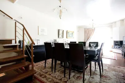 a dining room with a black table and chairs at Veggie Garden Athens B&B in Athens