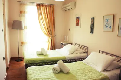 a room with two beds and a window at Veggie Garden Athens B&B in Athens