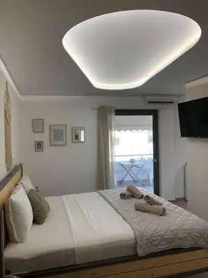 a bedroom with a large bed with a large white ceiling at Anastasia Suite/byArtistUnknown in Vari