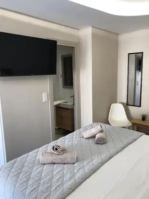 a bedroom with a bed with two towels on it at Anastasia Suite/byArtistUnknown in Vari