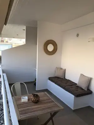 a room with a bench on the wall with a table at Anastasia Suite/byArtistUnknown in Vari