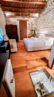 a bedroom with a bed and a table with a glass tray at The Cellar Studios - by Avelink in Spáta