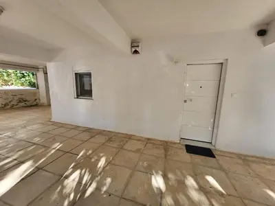 an empty room with a white wall and a door at Apartment Near The Center Of Glyfada in Athens