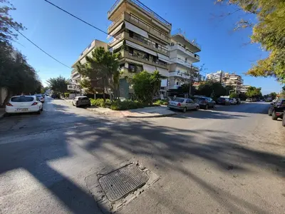 a street with cars parked on the side of a building at Apartment Near The Center Of Glyfada in Athens