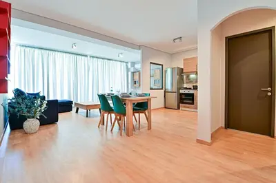 a living room with a table and green chairs at Cozy apartment located on Piraeus Port area-(SPETS_D1) in Piraeus