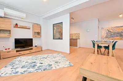 a living room with a table and a television at Cozy apartment located on Piraeus Port area-(SPETS_D1) in Piraeus