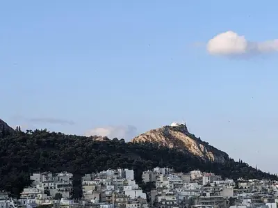 a group of white buildings on top of a mountain at Rooftop Studio with Acropolis & Sea view in Athens
