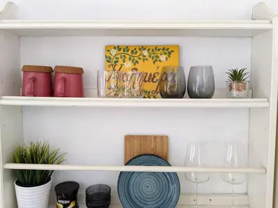 a shelf with dishes and vases on it at Rooftop Studio with Acropolis & Sea view in Athens