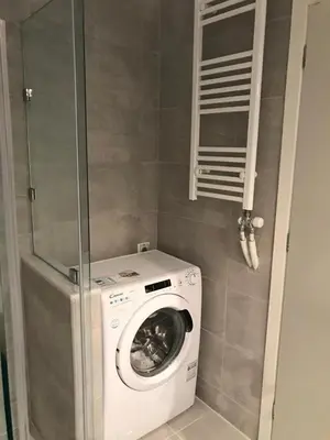 a washer and dryer in a bathroom with at Apartment For 4 Ppl In N. Smirni in Athens