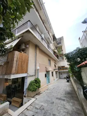 a building with a balcony on the side of it at Apartment For 4 Ppl In N. Smirni in Athens