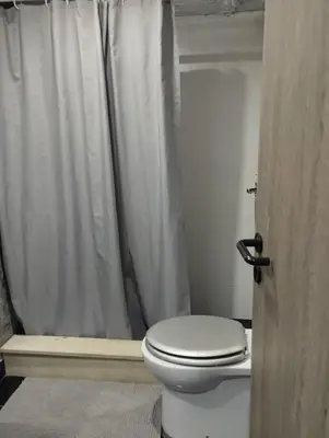 a bathroom with a toilet with a shower curtain at Studio47 in Athens