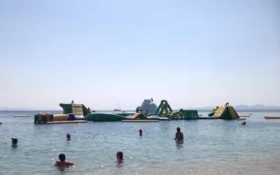 a group of people in the water at a beach at Studio47 in Athens