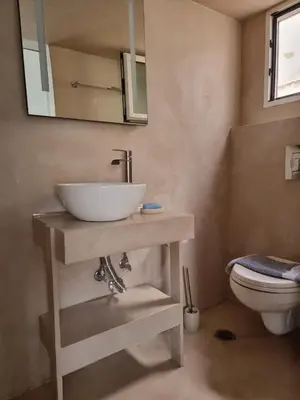 a bathroom with a sink and a toilet at Stylish studio in Glyfada in Athens