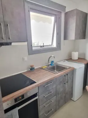 a small kitchen with a sink and a window at Stylish studio in Glyfada in Athens