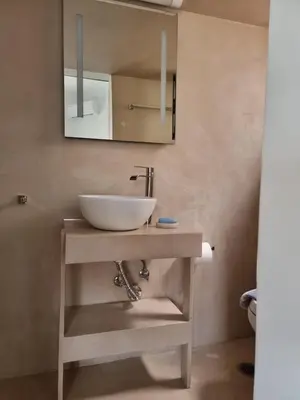 a bathroom with a sink and a mirror at Stylish studio in Glyfada in Athens