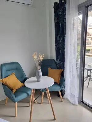 a living room with two chairs and a table at Stylish studio in Glyfada in Athens