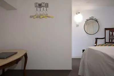 a room with a bed and a table and a mirror at Seabreeze apartment in Palaio Faliro/ Netflix in Athens
