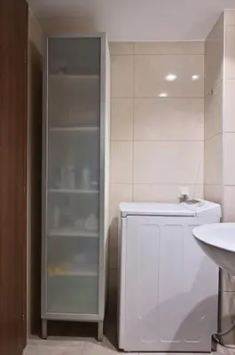 a bathroom with a white refrigerator and a sink at Seabreeze apartment in Palaio Faliro/ Netflix in Athens