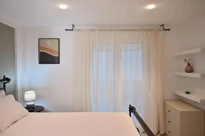 a bedroom with a white bed and a window at Seabreeze apartment in Palaio Faliro/ Netflix in Athens