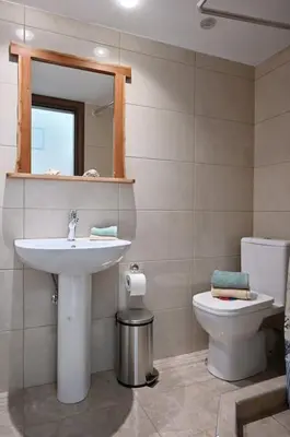 a bathroom with a sink and a toilet at Seabreeze apartment in Palaio Faliro/ Netflix in Athens