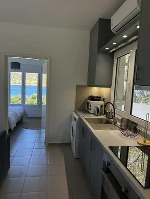 a kitchen with a sink and a counter top at Coast Cottage Porto Rafti-Avlaki by BRP-Properties in Porto Rafti
