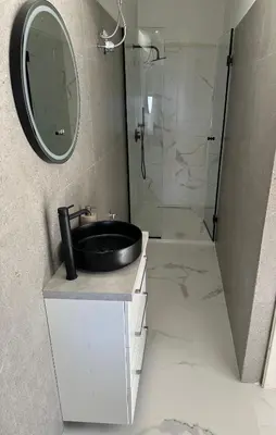 a bathroom with a sink and a shower at Coast Cottage Porto Rafti-Avlaki by BRP-Properties in Porto Rafti