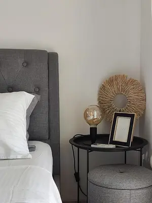 a bedroom with a bed and a table with a mirror at Varkiza Sea View Apartment - Free Parking in Vari