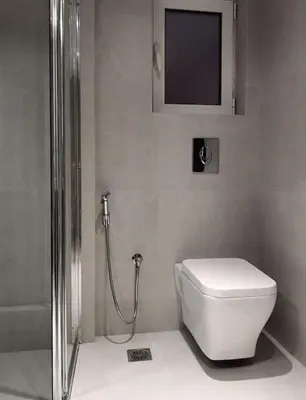 a bathroom with a toilet and a shower and a television at Varkiza Sea View Apartment - Free Parking in Vari