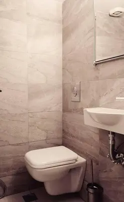 a bathroom with a white toilet and a sink at Varkiza Sea View Apartment - Free Parking in Vari