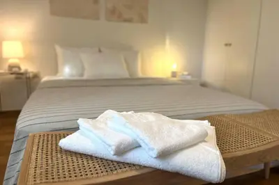 a bed with white towels on a wooden table at Pame Rentals - 1BD Apartment with Sea View in Athens