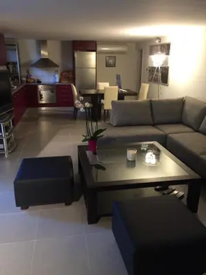 a living room with a couch and a table at Glyfada's Luxury Apartment in Athens