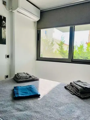a room with two towels on the floor and a window at Glyfada's Luxury Apartment in Athens