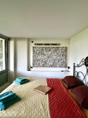 a bedroom with a large bed with a window at Glyfada's Luxury Apartment in Athens