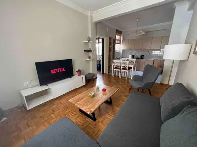 a living room with a couch and a table at Family Apartment “Atene” in Athens