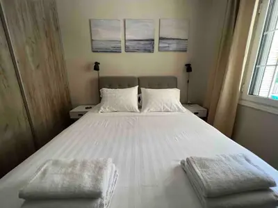 a bedroom with a large white bed with two pillows at Family Apartment “Atene” in Athens