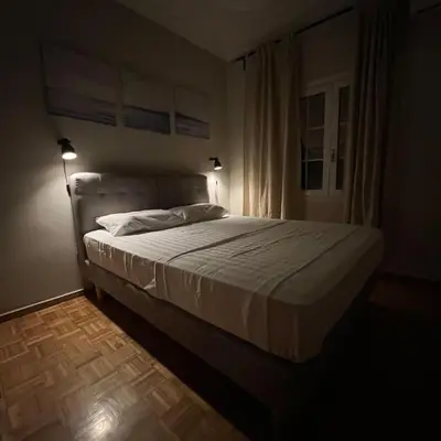 a bedroom with a large bed in a room at Family Apartment “Atene” in Athens