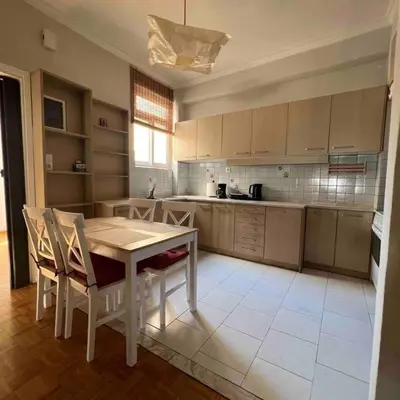 a kitchen with a table and chairs in a room at Family Apartment “Atene” in Athens