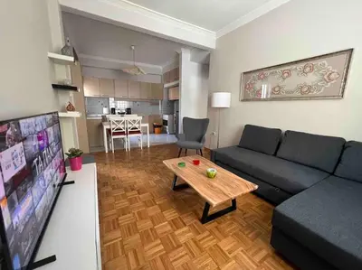 a living room with a couch and a table at Family Apartment “Atene” in Athens