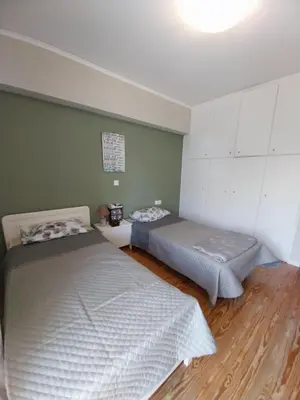 a room with two beds in a room at Hope house Kavouri in Athens