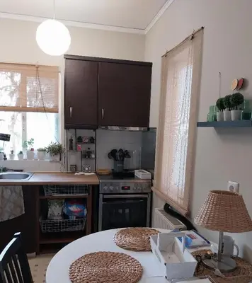 a kitchen with a table and a stove top oven at Hope house Kavouri in Athens