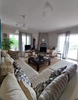 a living room with a couch and a table at Hope house Kavouri in Athens